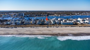An aerial view of a coastal residential area with beachfront properties, a marina, and a clear sky. - #9 Penthouse w/ 360 ocean & beach views in CB! (Carolina Beach)