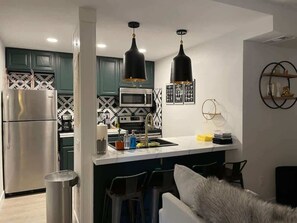 A modern kitchen with a central island, stainless steel appliances, and pendant lighting. - 2 Bd 3 Ba, Luxury Ski-in Ski Out Condo - Sleeps 10 (Park City)