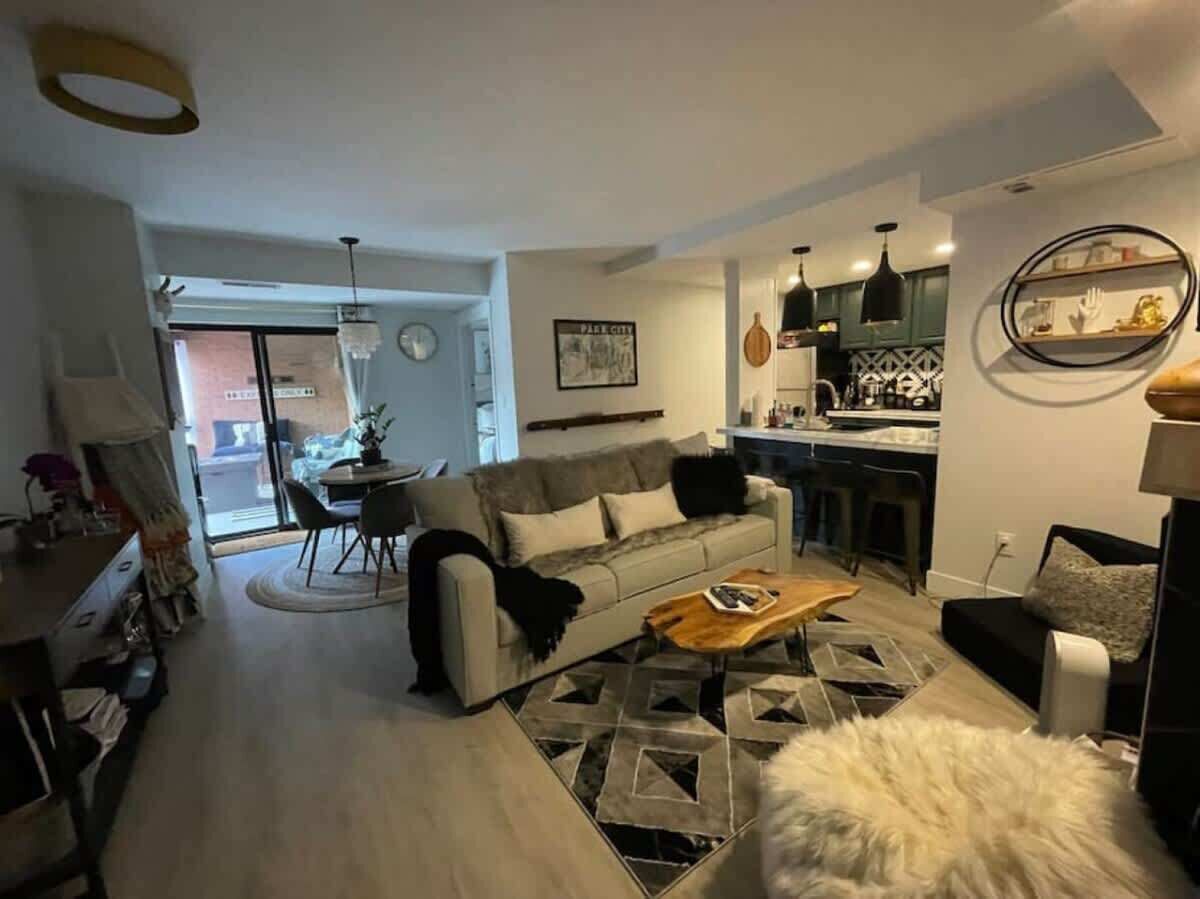 Una sala moderna con sofá, una mesa de centro y un comedor.