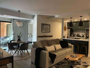 A modern living room with a sofa, coffee table, and dining area. - 2 Bd 3 Ba, Luxury Ski-in Ski Out Condo - Sleeps 10 (Park City)