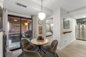 Enjoy a meal at the round dining table, with a city view from the large window.