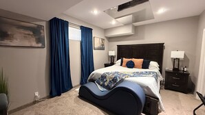 A modern bedroom with a bed, nightstands, a desk, and a chair. - Stay549 - Adults Only Bed and Breakfast  (Winnipeg)