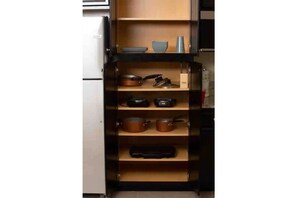 Kitchen features a cabinet system with multiple shelves for storing kitchen essentials.