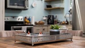 A kitchen with a microwave, stove, and various kitchen items on shelves. - RoosterHouse Countryside Pecan Farm 6ac SanMarcos (Maxwell)