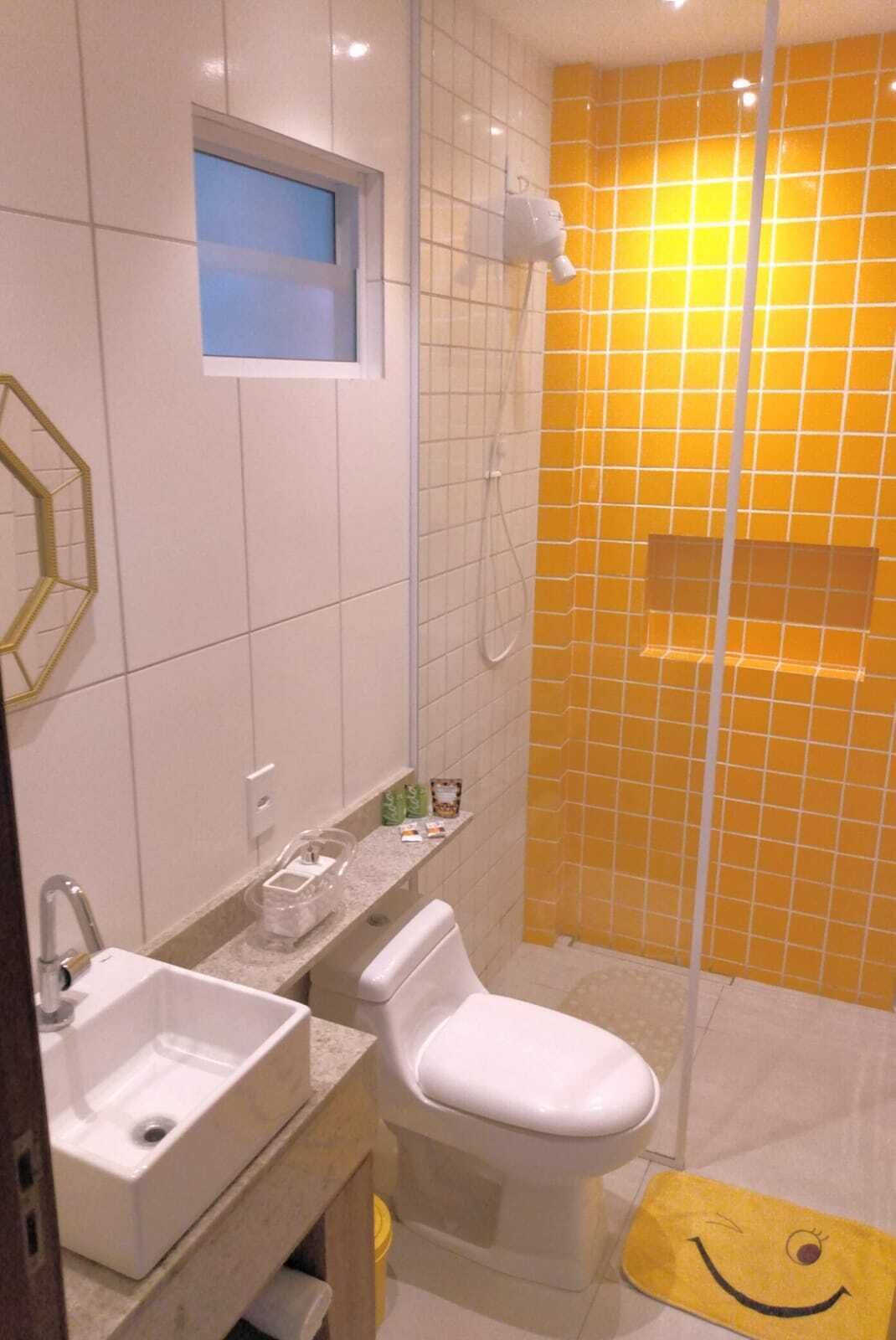 A bathroom with a white sink, toilet, and shower.
