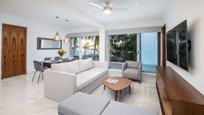 A modern living room with a sofa, coffee table, and TV.