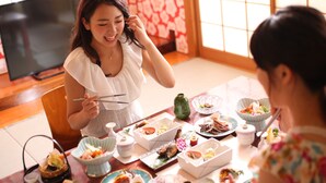 A dining table with various dishes and a television in the background.