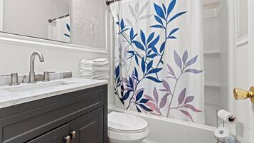 Combined shower/bathtub, towels, toilet paper