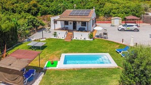 A house with a swimming pool, a covered patio, and a car parked in the driveway. - Cortijo Jimena by Solset (Málaga)