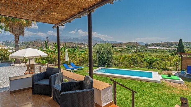 A covered outdoor area with a pool, lounge chairs, and a view of the countryside. - Cortijo Jimena by Solset (Málaga)