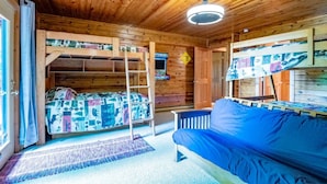 A cabin with a bunk bed, a sofa, and a ladder. - Bear Ridge - Valley Views, Hot Tub, Dog Friendly (Davis)