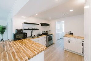 Enjoy cooking in this well-equipped kitchen with an oven, microwave, and sink.