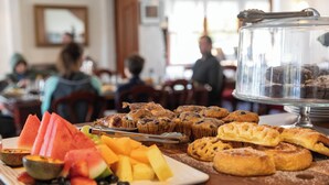 A breakfast buffet with various pastries and fresh fruit. - Girraween Country Inn (Eukey)