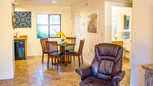 A dining area with a table, chairs, and a leather chair. - Eclectic boho style apartment in the heart of West Sedona (Sedona)