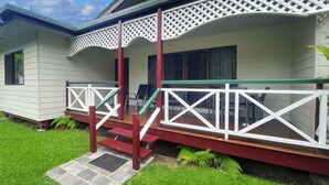 A house with a porch, steps, and a small garden. - Arcadia Gardens (Arcadia)