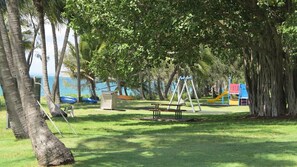 Ein Park mit Schaukeln, einem Picknicktisch und Spielgeräten.