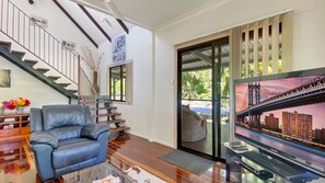 Relax in style with a sleek sofa and city views from the balcony.