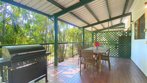 Enjoy al fresco dining on the patio, surrounded by lush tropical vegetation.