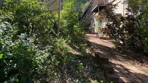 A pathway leading to a building with a sign that reads 'Captain's Manor.' - The Barracks Arcadia 2 (Arcadia)