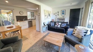 A modern living space with a kitchen, dining area, and seating area.