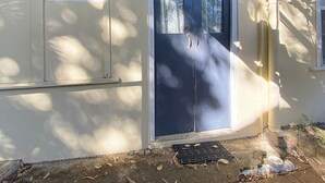 A building with a blue door, a window with a view, and a small vent. - The Captain's Manor on Cook 9 (Arcadia)