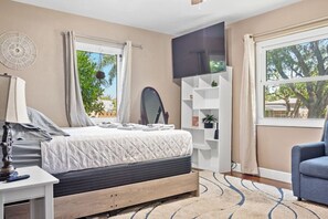Relax in this serene bedroom with a comfortable bed, bedside table, and flat-screen TV.