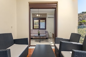 Un balcon agrémenté de meubles en osier, d’un canapé et d’une petite table.