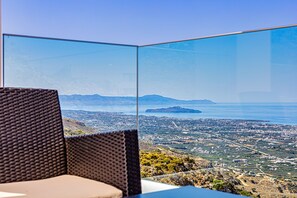 Enjoy breathtaking views of the coastal landscape from this room's balcony.