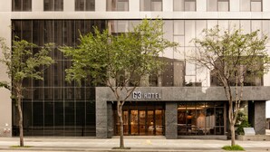 A modern hotel with a glass facade, a sign reading "G3 Hotel," and a few trees in front. - G3 Hotel Chungmuro (Seoul)