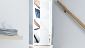 A staircase with wooden steps and a window at the top. - De Salon van Fagel (The Hague)