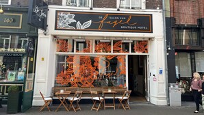 A boutique hotel with a distinctive floral window display and a sign reading "Salon Van Fabel Boutique Hotel". - De Salon van Fagel (The Hague)