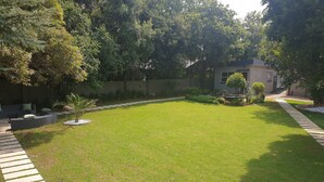 A well-maintained lawn with a stone pathway leading to a building. - FM GUEST LODGE (Randburg)
