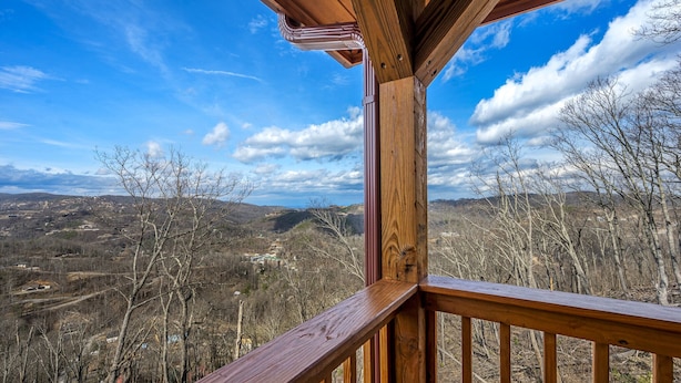 A wooden deck with a clear view of a mountainous landscape.