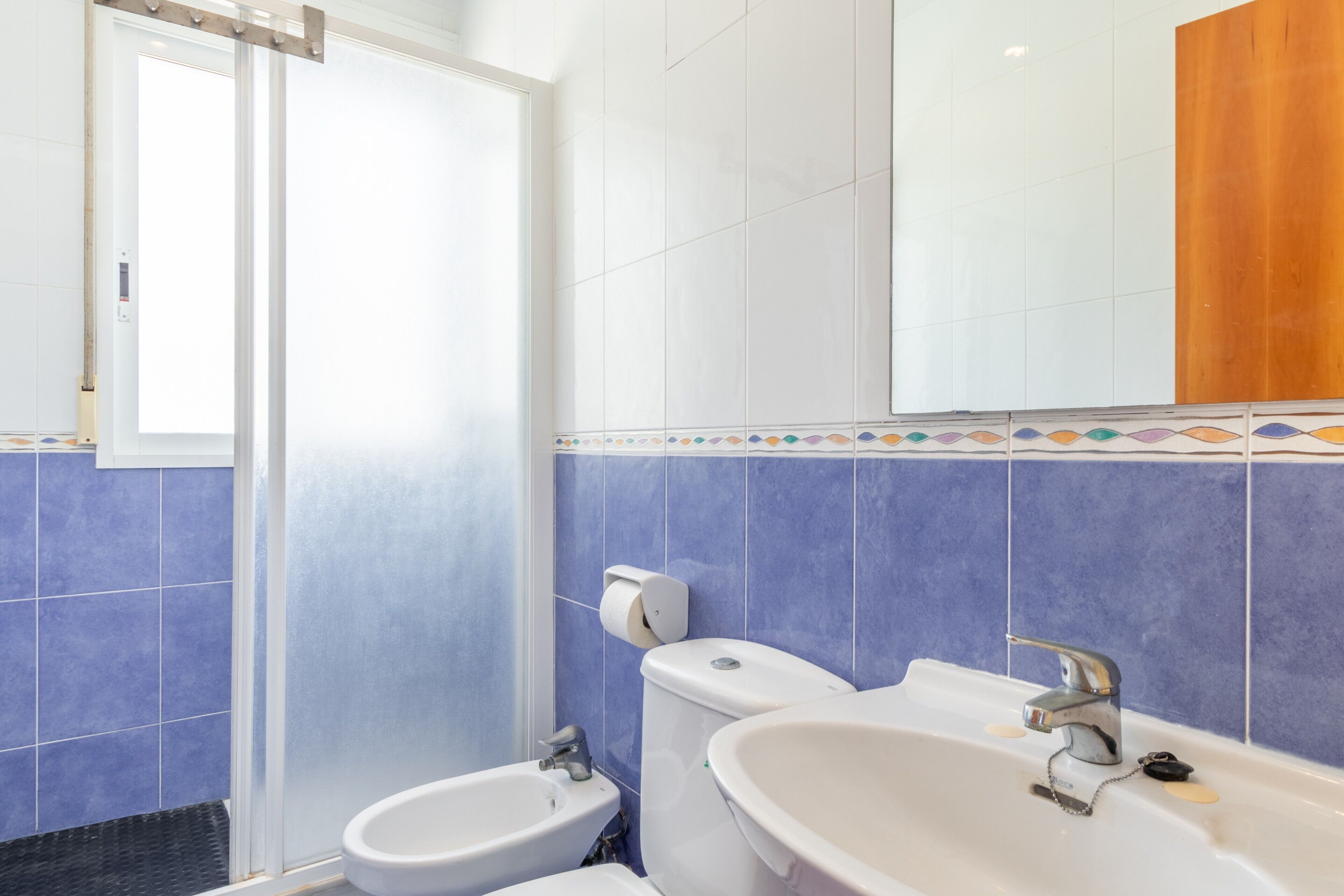 A bathroom with a toilet, bidet, and sink.