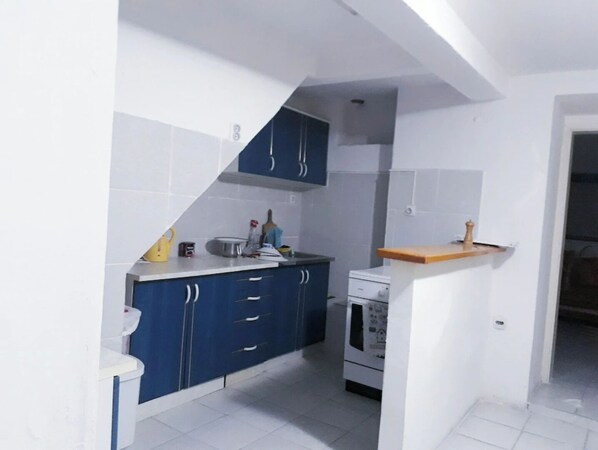 Functional kitchen with oven, microwave, sink, and ample workspace.