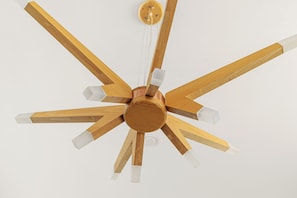 A ceiling fan with wooden blades and a central wooden hub. - Contemporary Compound By Homestead Modern (Joshua Tree)