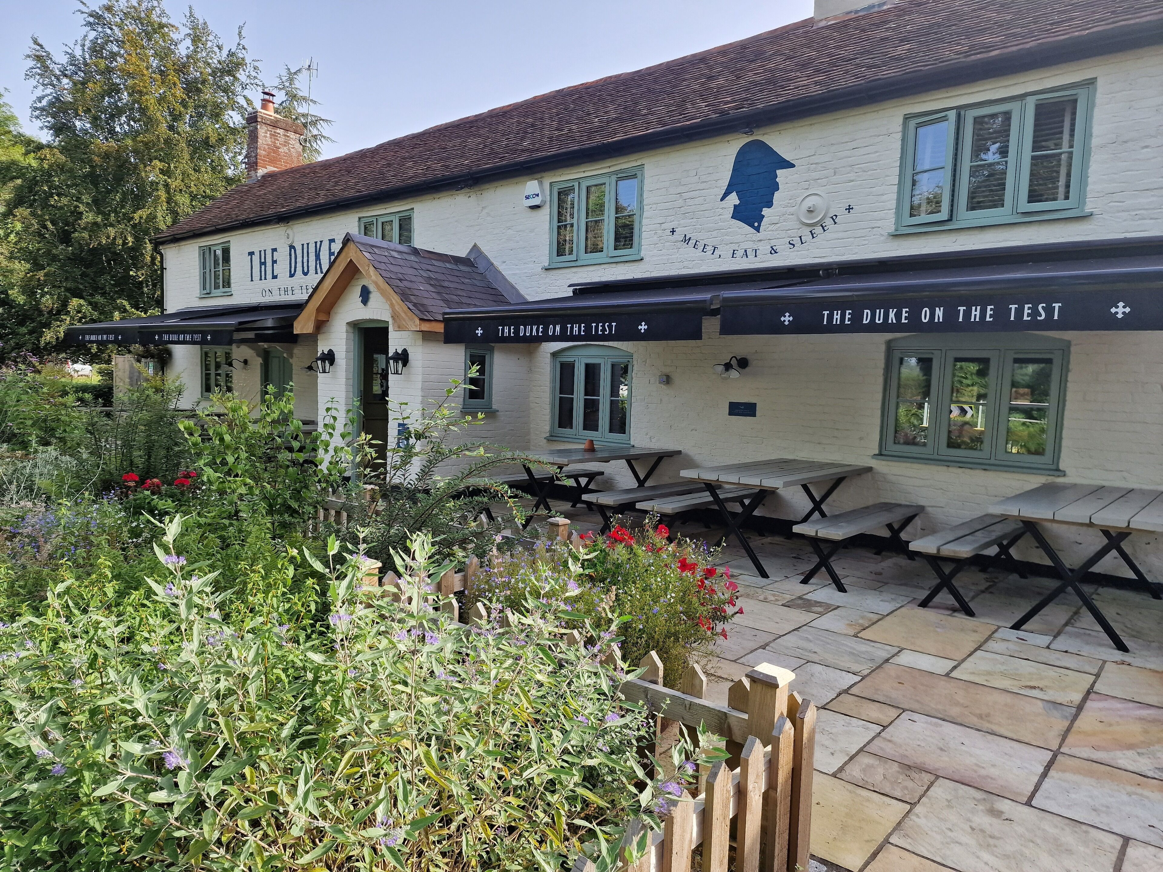 A building named "The Duke on the Test" with outdoor seating and a garden area.