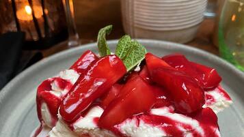 A dessert with strawberries and whipped cream on a plate.