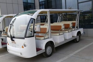 A white, three-wheeled vehicle with a covered top and seating arrangement. - Nanshanyuan Hotel (Xi'an)