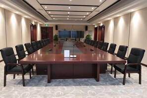 A conference room with a long table, chairs, and a projector screen. - Nanshanyuan Hotel (Xi'an)