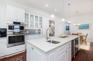 Fridge, dishwasher, coffee/tea maker, cookware/dishes/utensils