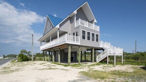 A two-story house with a balcony and a covered porch.