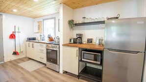 A modern kitchen with stainless steel appliances, wooden cabinets, and a built-in microwave. - Hydrus cozy 2 bedroom cottage (Kawartha Lakes)