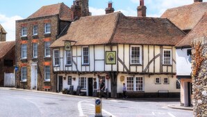 Un pub tradicional con entramado de madera a la vista y un letrero que dice "The Plough".