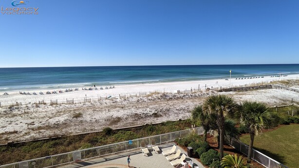 A beach view with a clear sky, a sandy beach, and a few people. - Azure 414 - 3 Bd Beachfront w/ Premium Amenities - Sleeps 8! (Fort Walton Beach)