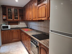 Fridge, oven, coffee/tea maker, cookware/dishes/utensils