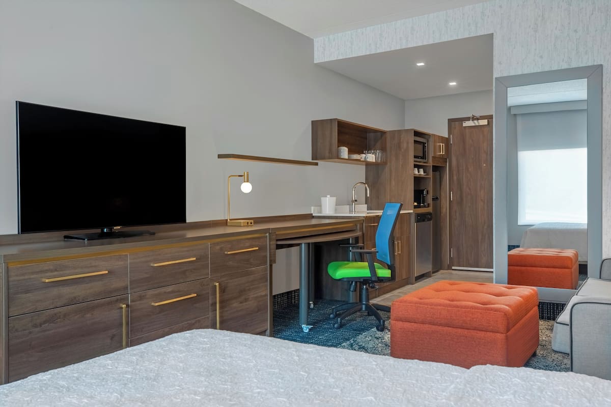 Desk, laptop workspace, iron/ironing board, bed sheets