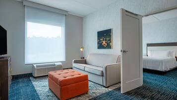 Desk, laptop workspace, iron/ironing board, bed sheets