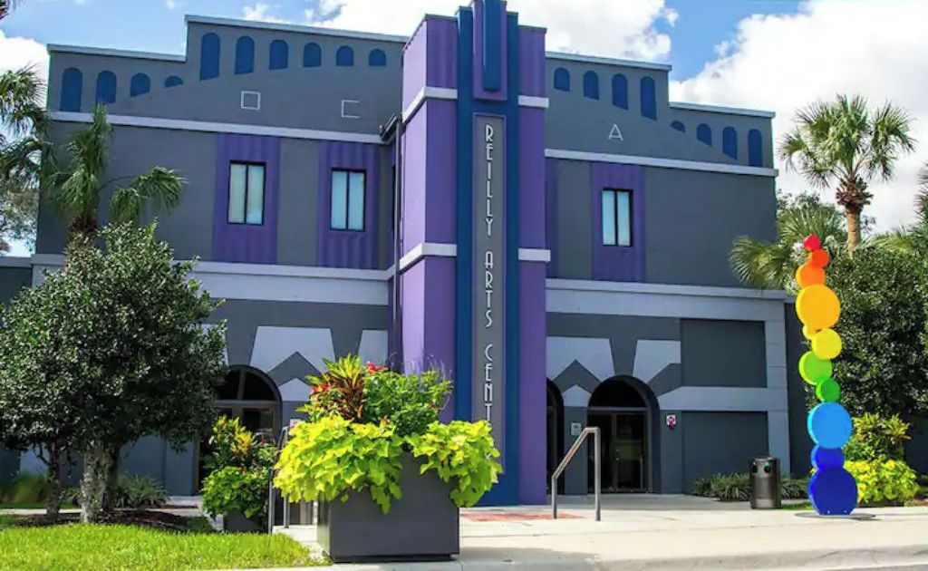 The exterior of the Reilly Art Center with a modern architectural design, featuring a prominent entrance and surrounding greenery.