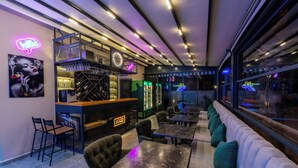 A bar area with seating and a neon sign. - EURONOVA HOTEL & SUITES (Kemer)